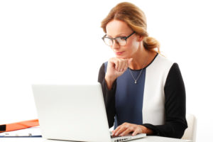 Woman at Computer /Money Coaches Canada Blog